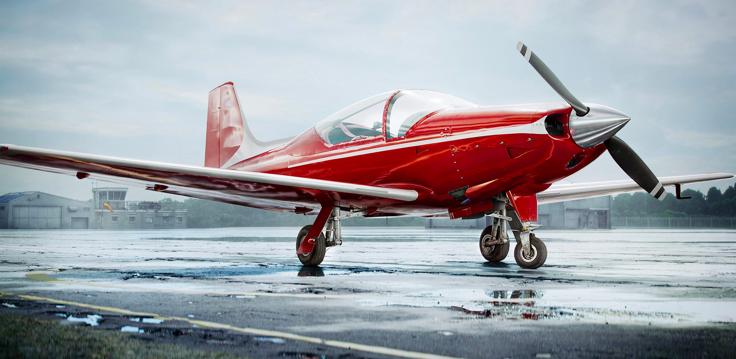 Falco F8L on a wet airfield at dusk